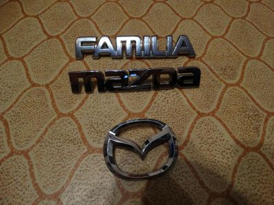 Лот: 5189628. Фото: 1. Шильдики Mazda end Familia. Кузов